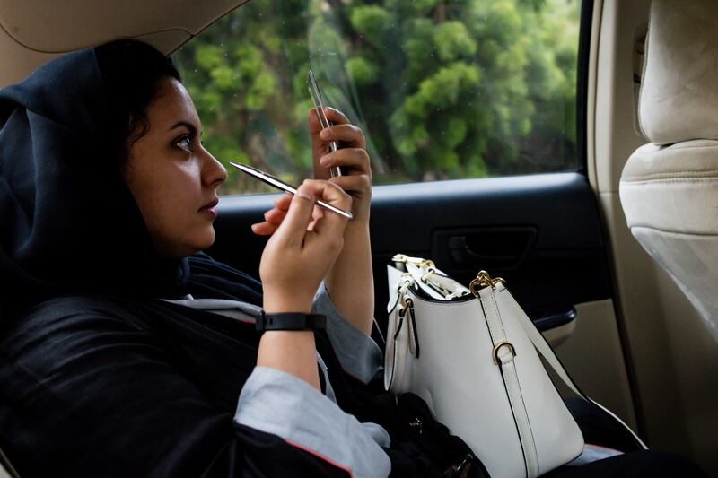 A woman applies make-up while travelling in a taxi cab operated by Uber Technologies Inc. in Jeddah, Saudi Arabia, on Sunday, Aug. 6, 2017. After relying on oil to fuel its economy for more than half a century, Saudi Arabia is turning to its other abundant natural resource to take it beyond the oil age -- desert. Photographer: Tasneem Alsultan/Bloomberg
