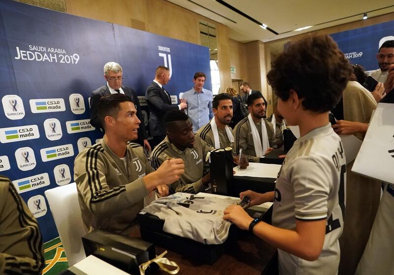 Cristiano Ronaldo signs a fans shirt. Getty Images