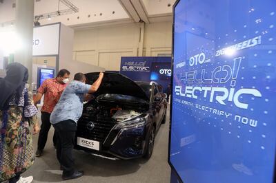 Visitors look at the motor compartment of a Nissan Kicks E-Power electric car during the Gaikindo Indonesia International Auto Show 2021 in Tanggerang, Indonesia in November 2021. EPA