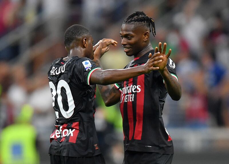 Rafael Leao and Pierre Kalulu celebrate after AC Milan's win over Inter Milan. Reuters