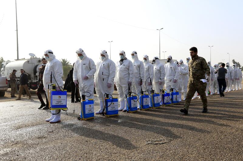 Members of the medical team during precautionary measures against the novel coronavirus outbreak in the holy city of Karbala, southern Baghdad.  EPA
