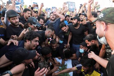 Mourners react next to the coffin of Iraqi civil society activist Ihab Al Wazni, who was killed by unidentified gunmen, during a funeral in Karbala, Iraq. Reuters