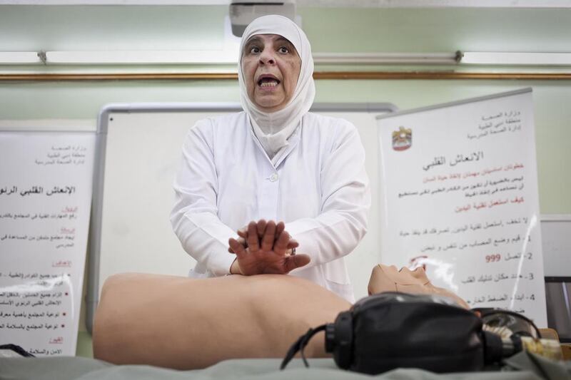 Dubai, United Arab Emirates - September 19 2013 - Weam Fayed, Nurse and American Heart Instructor gives a CPR lecture to teachers at the Al Mahalab School in Dubai. The training is overlooked by the Ministry of Health and is done once a year in order to refresh the teachers with the knowledge of CPR and First Aid. Journalist: Manal Ismail Section: NATIONAL. (Razan Alzayani / The National) *** Local Caption ***  RA0919_CPR_training_schools_07.jpg