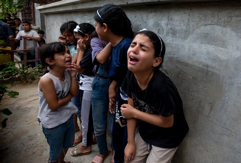 Children cry during the funeral of Tamim Hijazi in Khan Yunis, a city in the southern Gaza Strip. The Gaza resident was killed in an Israeli air strike. AP