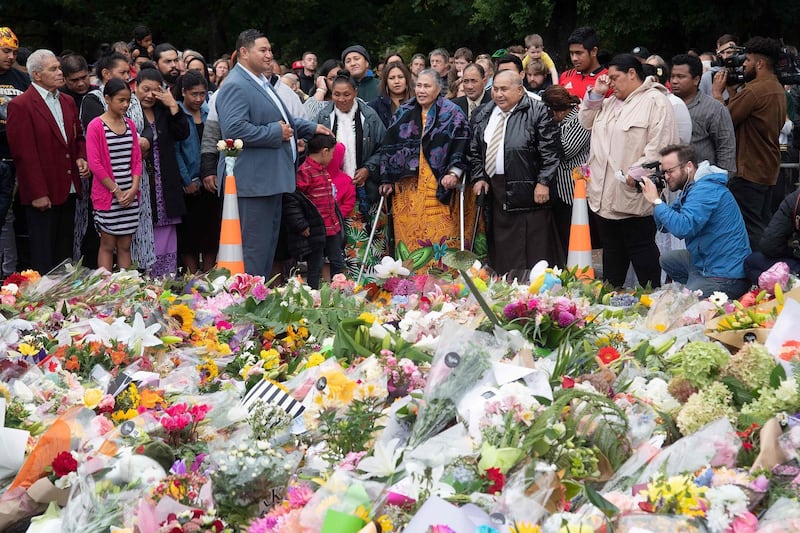 Samoan church members sing next to floral tributes in Christchurch on March 17, 2019. AFP