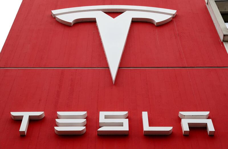 FILE PHOTO: FILE PHOTO: The logo of car manufacturer Tesla is seen at a branch office in Bern, Switzerland October 28, 2020. REUTERS/Arnd Wiegmann/File Photo/File Photo
