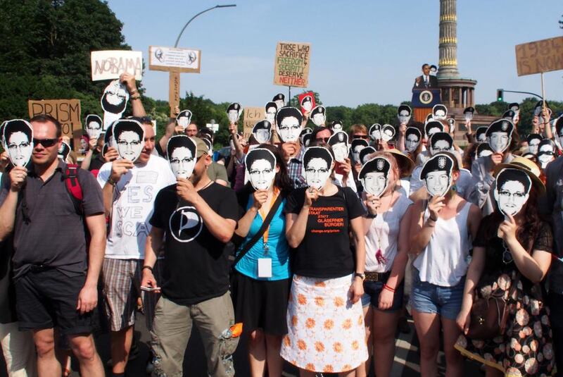 Protesters against the National Security Agency’s PRISM surveillance programme wear masks of US whistleblowers Edward Snowden and Bradley Manning, in June 2013 in Berlin, after US president Barack Obama defended the programme on his visit. Chad Buchanan / Getty Images