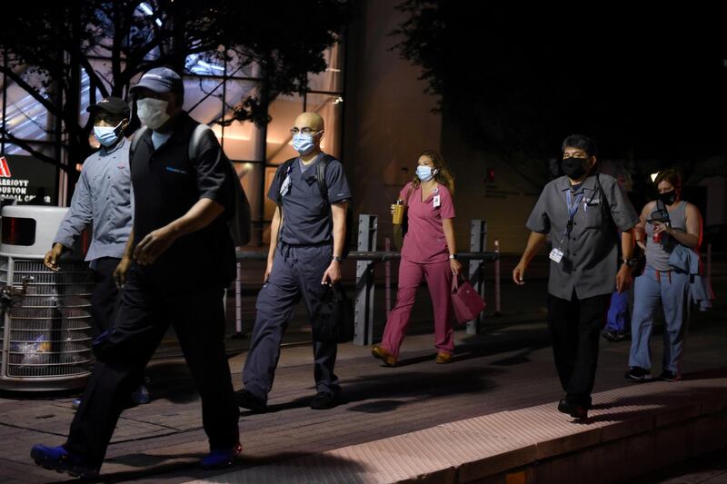 Healthcare workers walk through the Texas Medical Centre during a shift change in Houston. Reuters