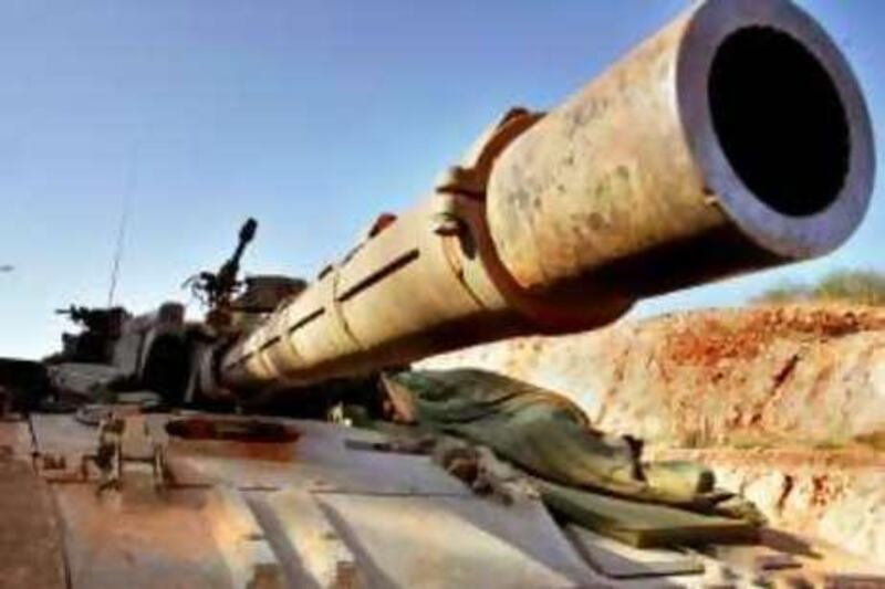 An Israeli soldier sleeps atop a tank parked along the international border with Lebanon, moments after crossing back into Israel 18 August 2006. Israeli Deputy Prime Minister Shimon Peres said yesterday he expected Israel's military to have withdrawn from southern Lebanon in a matter of weeks, as part of its commitment to a UN-brokered ceasefire.  AFP PHOTO/GALI TIBBON