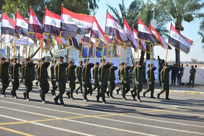 Members of Iraq's Popular Mobilisation Forces take part in a parade to mark the seventh anniversary of the organisation's founding at Camp Ashraf in Diyala province. AFP