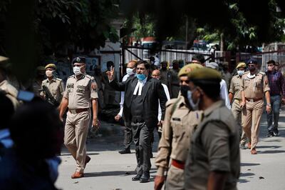 Vimal Kumar Srivastava, defence counsel in the 1992 attack and demolition of a 16th century mosque, displays the victory symbol as he leaves a court in Lucknow, India, Wednesday, Sept. 30, 2020. An Indian court on Wednesday acquitted all 32 accused, including four senior leaders of the ruling Hindu nationalist Bharatiya Janata Party, in the case.  The demolition sparked Hindu-Muslim violence that left some 2,000 people dead. (AP Photo/Rajesh Kumar Singh)