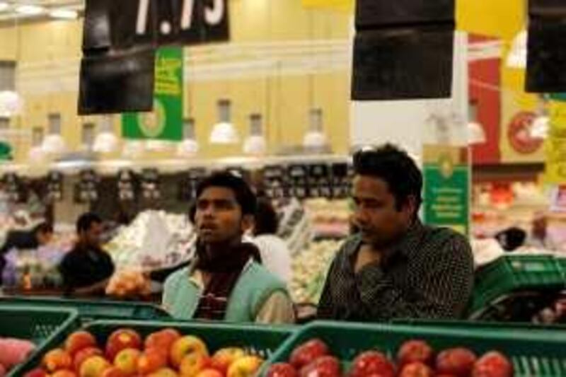 DOHA, QATAR - February 19, 2009: Men shop for produce, fruit and vegetables at Carrefour in the City Centre - Doha, shopping mall.
( Ryan Carter / The National )

stock *** Local Caption ***  RC005-ShoppingQatarB.JPG