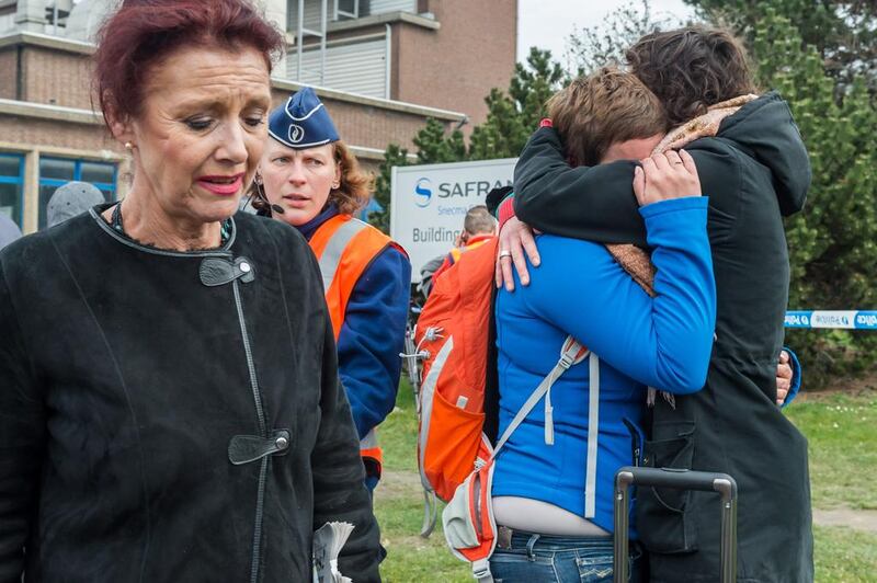 People react outside Brussels airport after two explosions rocked the facility on March 22, 2016. Geert Vanden Wijngaert/AP Photo