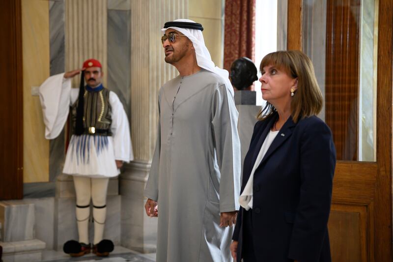 President Sheikh Mohamed Ms Sakellaropoulou stand for the UAE and Greek national anthems.