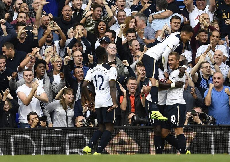 Tottenham’s Harry Kane celebrates scoring their first goal with teammates Dele Alli and Victor Wanyama on Sunday. Dylan Martinez / Reuters