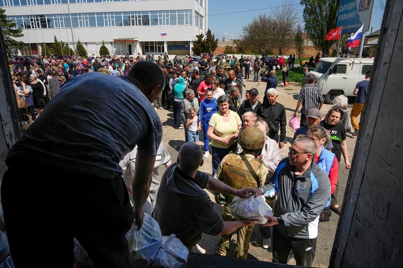 Civilians gather for humanitarian aid, distributed by the Donetsk People Republic Emergency Situations Ministry in Berdyansk, in territory under the government of the Donetsk People's Republic, eastern Ukraine. AP