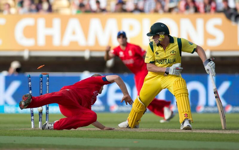 England's James Tredwell, left, dives to field the ball next to Australia's James Faulkner during the ICC Champions Trophy group A cricket match between England and Australia at Edgbaston cricket ground in Birmingham, England, Saturday, June 8, 2013.  (AP Photo/Matt Dunham) *** Local Caption ***  Britain ICC Trophy England Australia Cricket.JPEG-0e66a.jpg