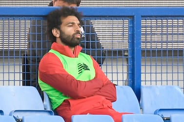 Liverpool's midfielder Mohamed Salah sits on the bench during Mersey derby.AFP