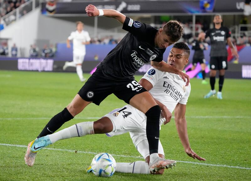 Real Madrid's Brazilian midfielder Casemiro tackles Eintracht Frankfurt's Jesper Lindstrom in the Uefa Super Cup in  Helsinki. AP