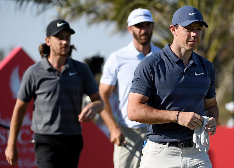 ABU DHABI, UNITED ARAB EMIRATES - JANUARY 19:  Rory McIlroy of Northern Ireland, Dustin Johnson of the United States and Tommy Fleetwood of England walk from the 14th tee during round two of the Abu Dhabi HSBC Golf Championship at Abu Dhabi Golf Club on January 19, 2018 in Abu Dhabi, United Arab Emirates.  (Photo by Ross Kinnaird/Getty Images)