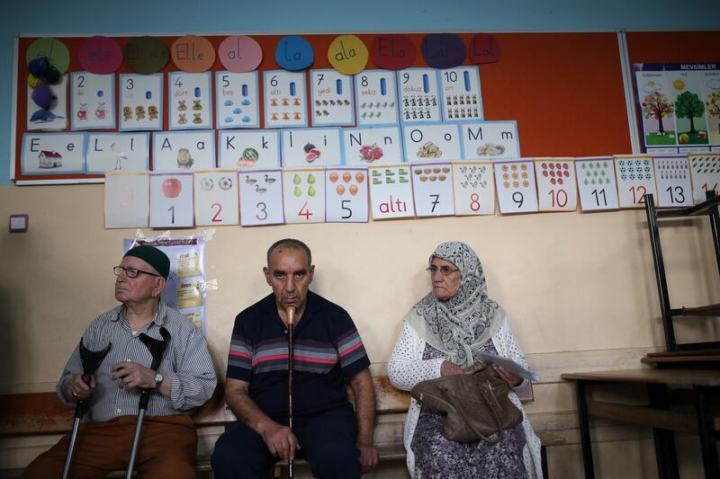 People wait to vote in Turkey's elections at a polling station in the mainly-Kurdish city of Diyarbakir, Turkey, on June 24, 2018. Emre Tazegul / AP Photo