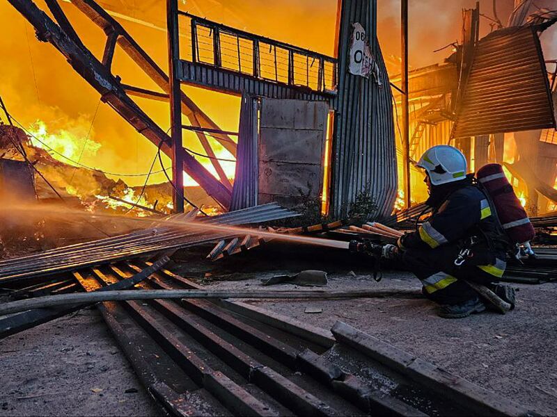 Ukrainian emergency teams out a fire in Lviv. EPA