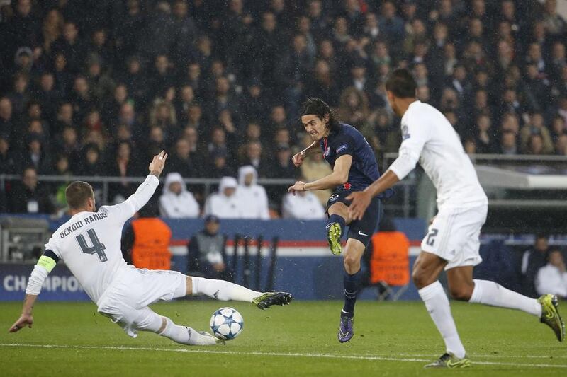 Paris Saint-Germain’s Edinson Cavani attempts a shot past Real Madrid defender Sergio Ramos during their Champions League match on Wednesday night. Thomas Samson / AFP