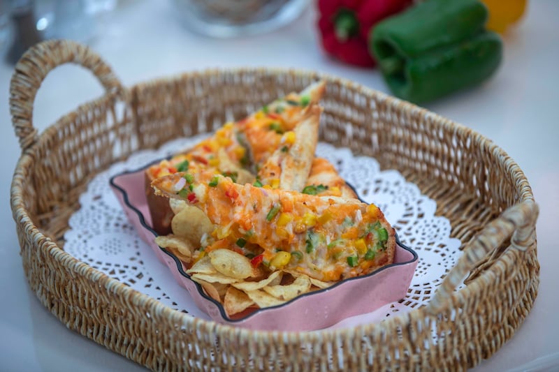 The cheese chilli toast comes with a sprinkling of locally popular Oman chips