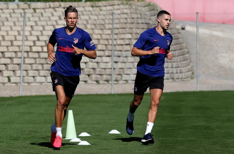 Mario Hermoso (R) and Marcos Llorente (L) during a training session at Wanda Sport City. EPA