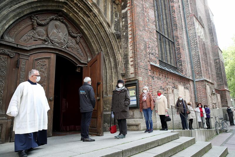 People arrive at Frauenkirche 'Cathedral of Our Lady'  for evening mass on the first day churches and other houses of worship are allowed to hold services again in Bavaria, Germany. Getty