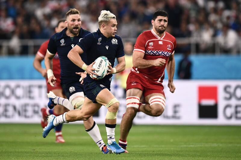 Scotland's wing Darcy Graham (C) runs with the ball prior to a pass leading to a try  during the Japan 2019 Rugby World Cup Pool A match between Scotland and Russia at the Shizuoka Stadium Ecopa in Shizuoka. AFP