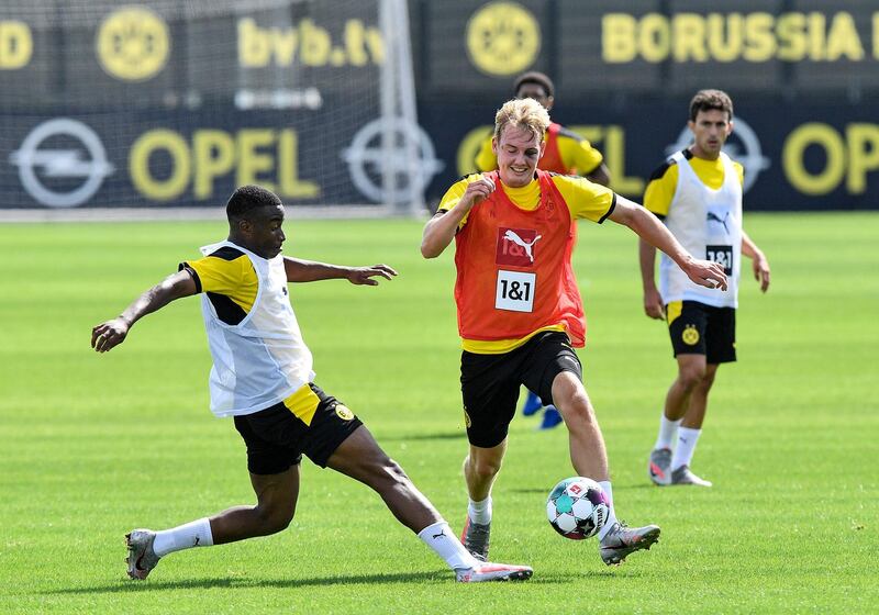 Borussia Dortmund's Youssoufa Moukoko, left, fights for the ball with Julian Brandt during team's first pre-season training session on Monday. AP