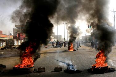 Tyres set alight by Sudanese protesters in Khartoum after military forces attacked a protest site outside the army headquarters on Monday. Reuters