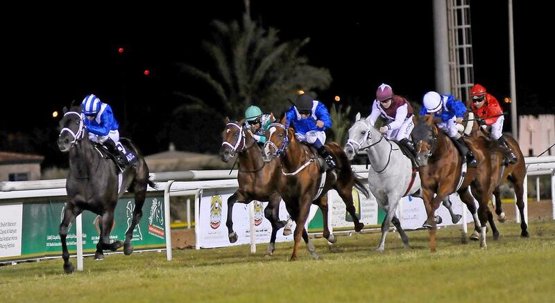 Udabaa and Paul Hanagan, left, pull away from the field in the 2,400-metre thoroughbred race Sunday at Abu Dhabi Equestrian Club. Ravindranath K / The National