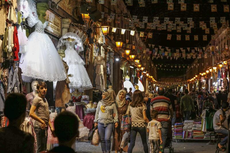 Syrians shop at the Hamidiya market ahead of Eid Al Fitr in the capital Damascus. AFP