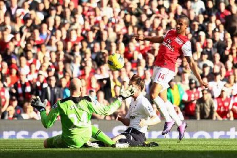 Theo Walcott scores his first and Arsenal's fourth goal in the Gunners' 5-2 win against Tottenham.