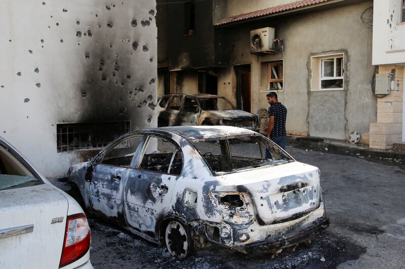 A car burnt during clashes in Tripoli. Reuters