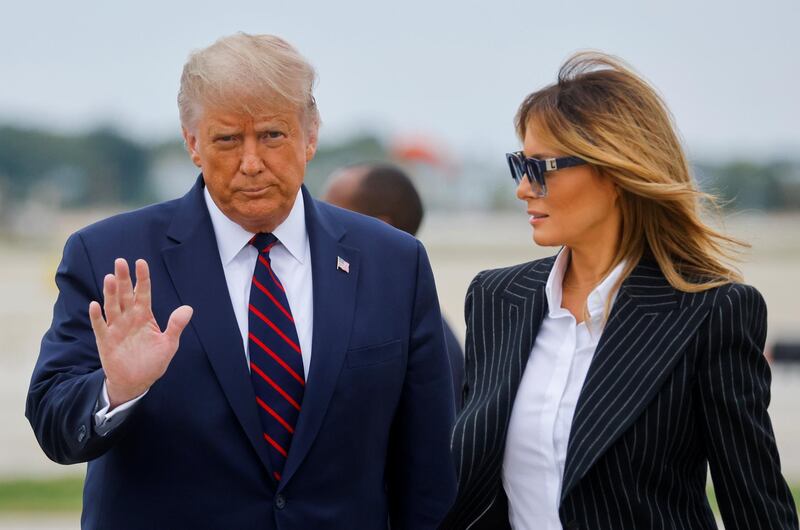 US President Donald Trump waves next to first lady Melania Trump as they arrive for his first 2020 election debate with Democratic presidential nominee Joe Biden at Cleveland Hopkins International Airport in Cleveland, Ohio, USA. Reuters