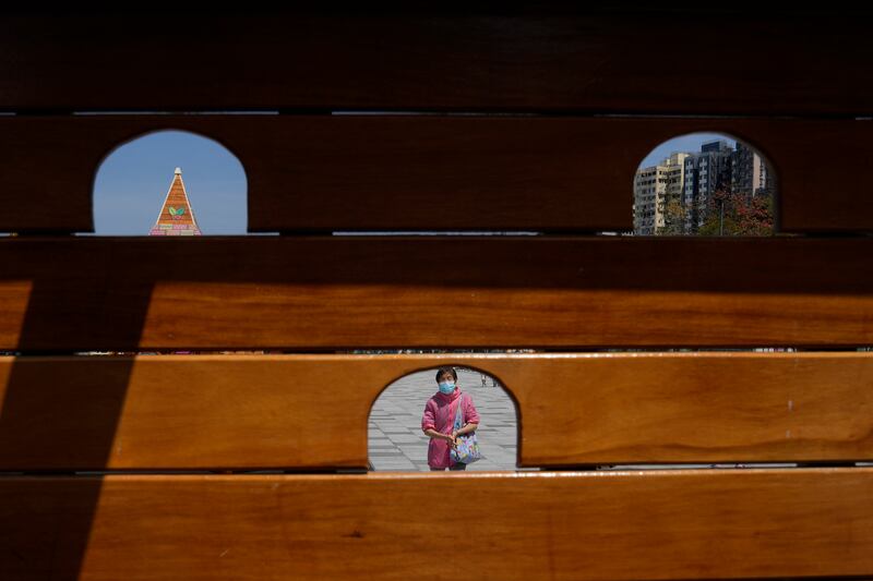 A woman walks in a park in Hong Kong. AP