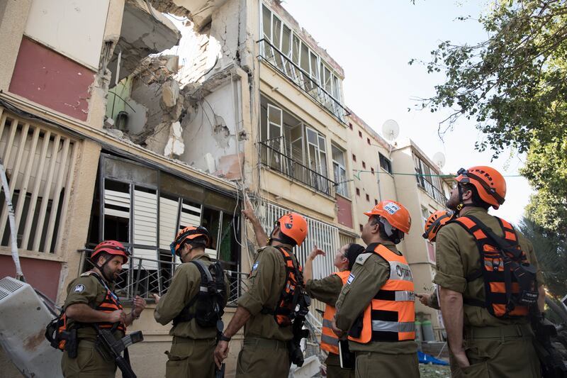 Army rescue crews assess the damage after a rocket fired from the Gaza Strip hit a building in Rishon LeTsiyon, Israel. Getty Images