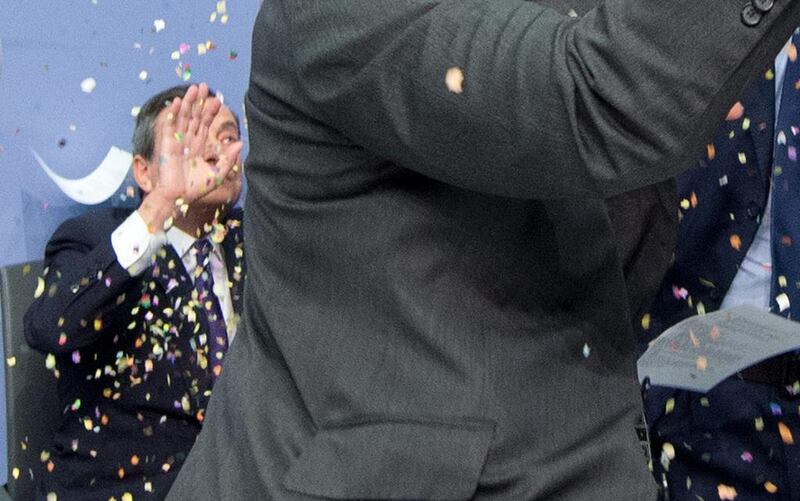 Mario Draghi is showered with confetti. EPA