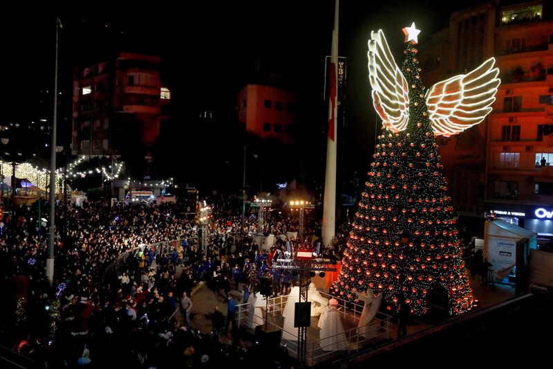 A crowd gathers for the illumination of a giant winged Christmas tree at Sassine Square, in the Achrafieh district of Lebanon's capital Beirut. AP Photo