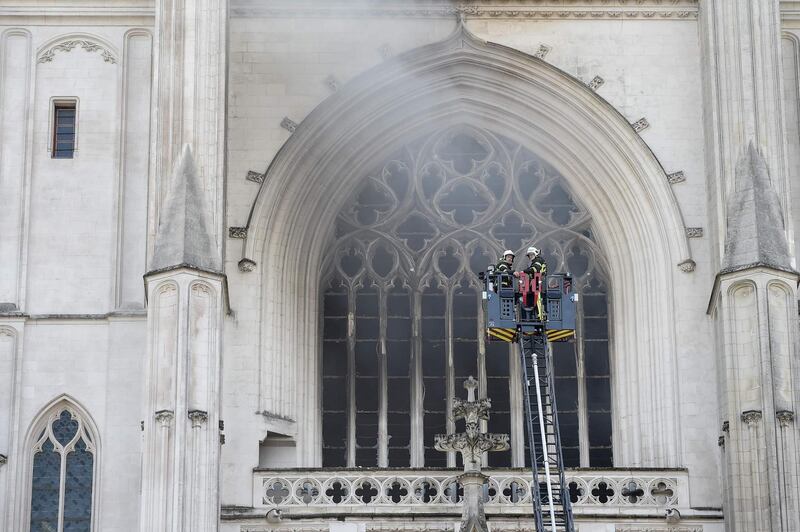 Firefighters work to put out a fire at the Saint-Pierre-et-Saint-Paul cathedral in Nantes, western France.  AFP