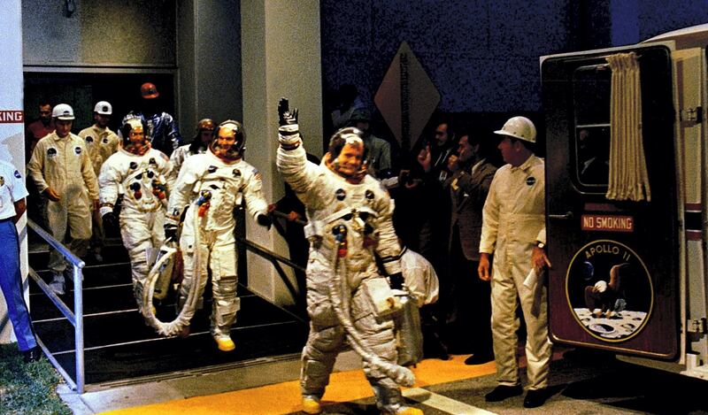 The crew men of the Apollo 11 lunar landing mission leave the Kennedy Space Center's (KSC) Manned Spacecraft Operations Building (MSOB) during the pre-launch countdown in this 16 July 1969 file photo. Astronauts Neil A. Armstrong, commander; Michael Collins, command module pilot; and Buzz Aldrin lunar module pilot, ride the special transport van over to Launch Complex 39A where their spacecraft awaited them. Lift-off was at 9:32 a.m. (EDT), 16 July1969. AFP PHOTO / NASA (Photo by HO / NASA / AFP)