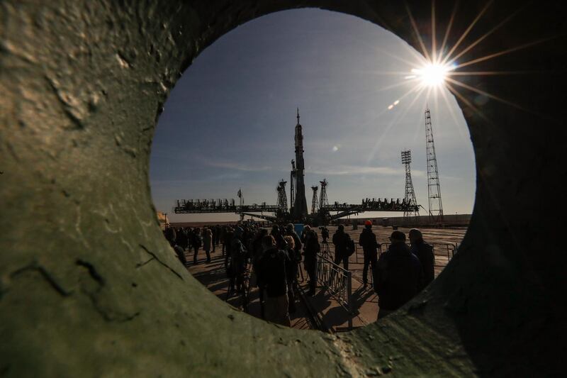 Tourists watch the installation of the Soyuz booster rocket with Soyuz MS-12 spacecraft being rolled out to the launch pad by train at the Baikonur Cosmodrome, Kazakhstan. EPA