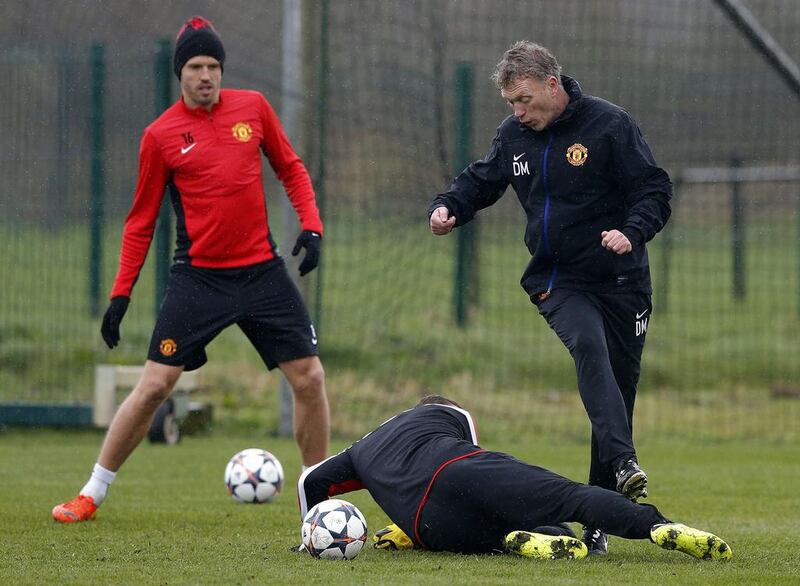 David Moyes is challenged by Wayne Rooney, ground, during Manchester United's training session on Tuesday. Phil Noble / Reuters / March 18, 2014