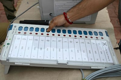 A man tests a Voter Verifiable Paper Audit Trail machine at an awareness camp in Mumbai ahead of India's upcoming parliamentary elections. AFP