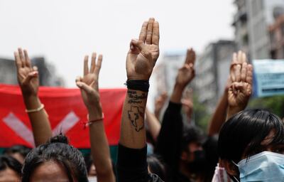 epa09161194 Demonstrators flash three-fingers salutes as they march  during an anti-military coup protest in Yangon, Myanmar, 26 April 2021. Myanmar activists have criticized the agreement between the junta leader and Association of Southeast Asian Nations (ASEAN) leaders after an emergency summit and have vowed to continue protests.  EPA/STRINGER