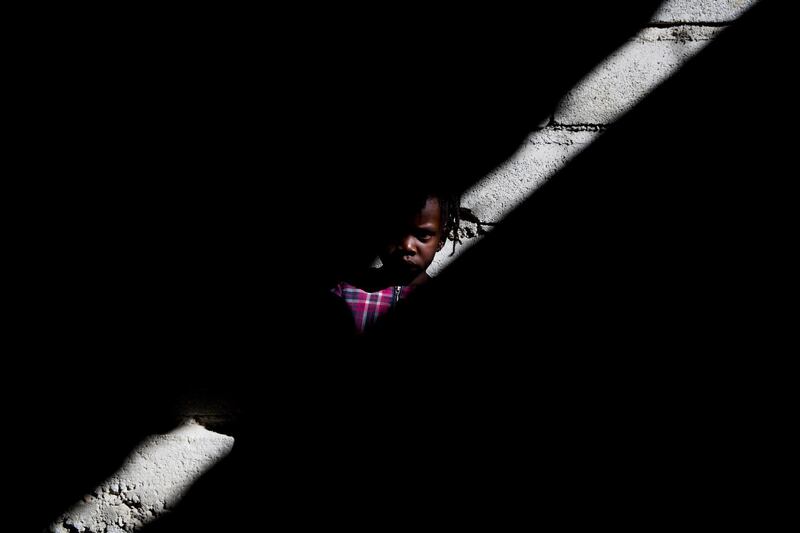 A girl looks on as hundreds of people live in the Corail camp for the displaced by the 2010 Haiti Earthquake, in Croix Des Buquets, Port-au-Prince, Haiti.  EPA
