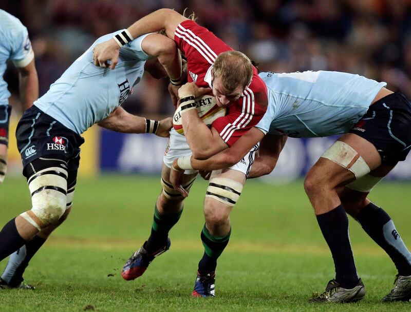 British and Irish Lions' Tom Croft, center, crashes through the Waratahs' Pat McCutcheon, left, and Ollie Atkins during a rugby union tour match at the Sydney Football Stadium in Sydney, Australia, Saturday, June 15, 2013. The Lions will play Australia in a 3-test series. (AP Photo/Rick Rycroft) *** Local Caption ***  APTOPIX Australia British Lions Rugby.JPEG-06bdd.jpg